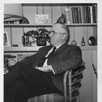 C. Ray Christianson seated at desk 1965