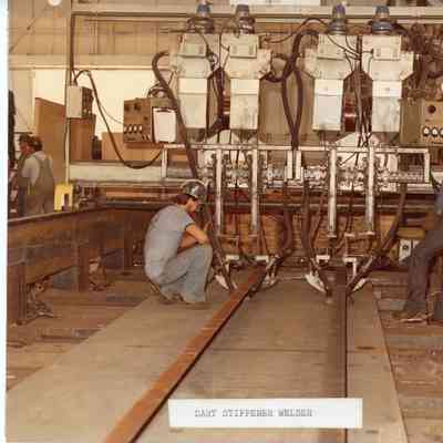 2 men monitoring dart stiffener welder