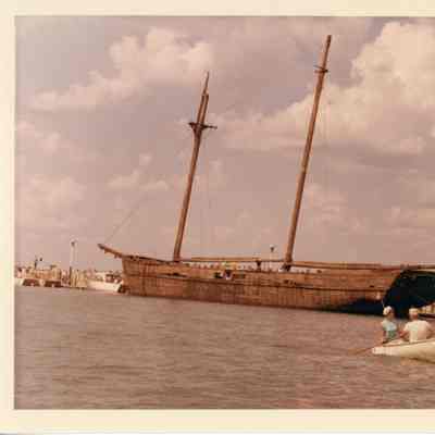 Portside view of the Alvin Clark with people on board