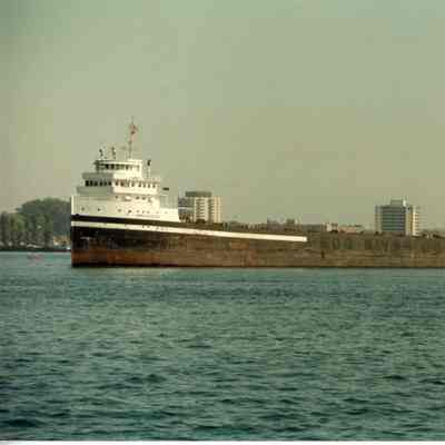 Freighter Spruceglen underway with city in background