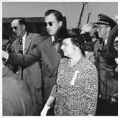 Leathem D. Smith and PC-825 ship sponsor Mrs. Zeidler in crowd by microphone