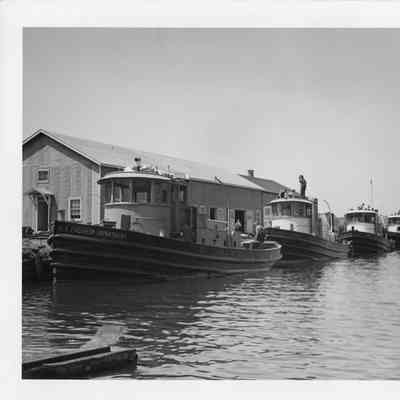 Tugboats Pilot, Escort, Convoy, and Scusset, dockside at Leathem D. Smith Shipbuilding Co.