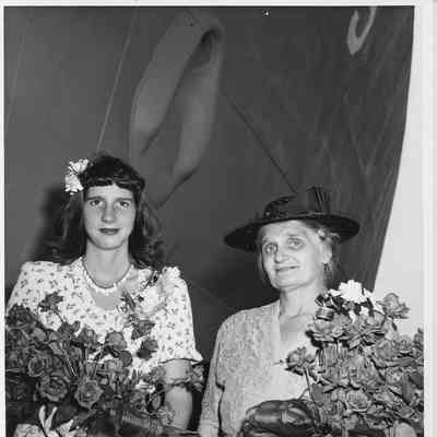 Miss Joan Burgess and Mrs. Cecilia Daniel standing in front of USS Chattanooga