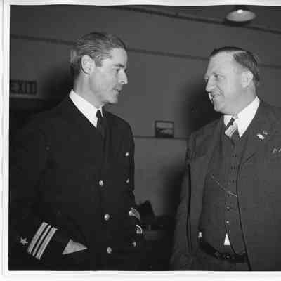 Unidentified man in uniform and C. Ray Christianson in suit