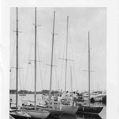 five sail boats docked