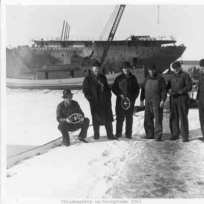 Men posing in front of the Steamer Humphrey in background 1944