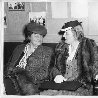 Two women sitting on couch