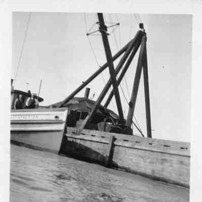 Two men on vessel Satisfaction docked