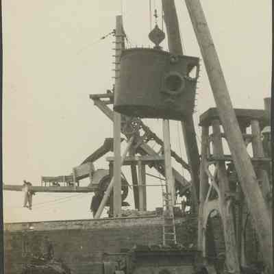 workers moving ship's boiler