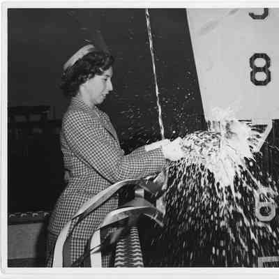 Miss Felice Ferguson smashing champagne bottle against bow of PC-821