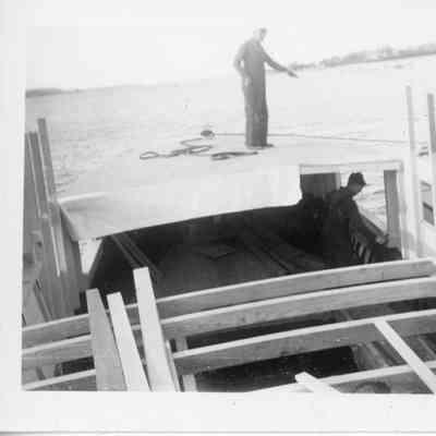 Two men building vessel