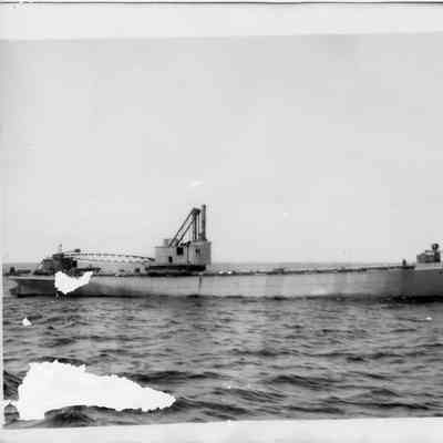 Tug or barge with dredger