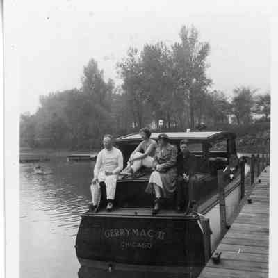 Four people sitting on stern of Gerrymac II