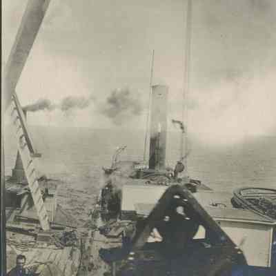 Workers guiding a bucket on crane