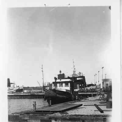 Tug boat tied to dock at SBSB&DD Co.