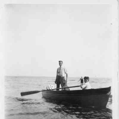 H.J. tuchscherer standing in rowboat on north shore of Lake Winnebago 1926