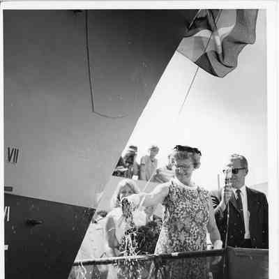 Woman holding broken christening bottle PG 93 Welch post-christening