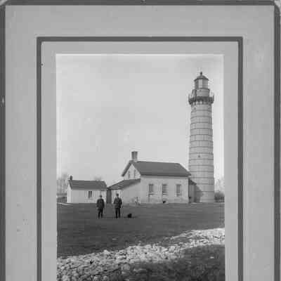 Two lighthouse keepers in front of Cana Island Lighthouse