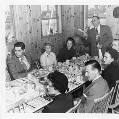 C. Ray Christianson eating with group at table