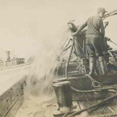 Worker pumping water