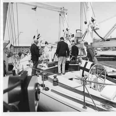 Several men standing on bard Kittyhawk at Palmer Johnson
