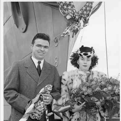 Arthur D. Kettner and Hellen Kettner holding roses and Champagne at PGM 32 christening