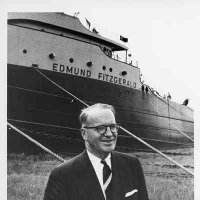 Mr. Edmund Fitzgerald standing on grass in front of the Edmund Fitzgerald