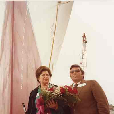 Two people with flowers alongside ship during christening of Napolean