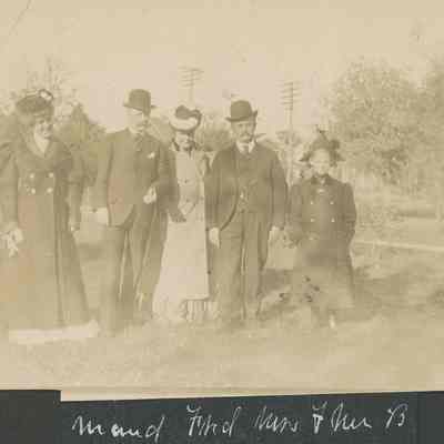 group of five posing for photo in dress clothes