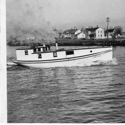 Fishing tug John V. Allie underway with shore in background