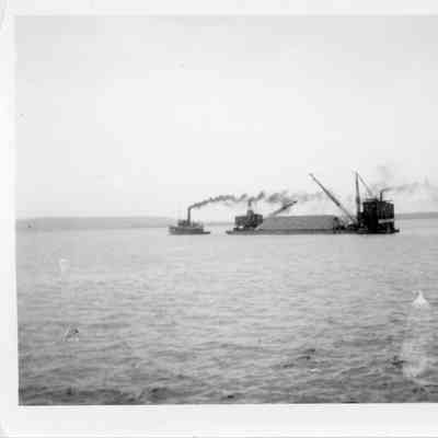 Barge Transport being towed by tugboat