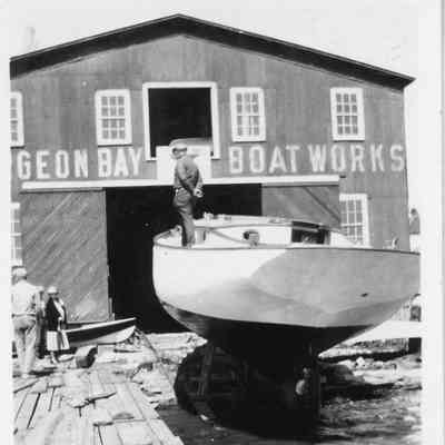 Sailboat in cradle in front of Sturgeon Bay Boat Works