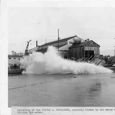 Fire Boat Victor L. Schlaeger being launched hidden by spray