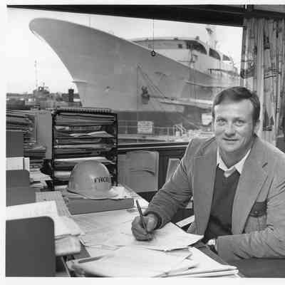 Fred Peterson II at desk