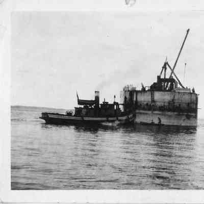 Two tugboats next to structure in water September 9, 1917
