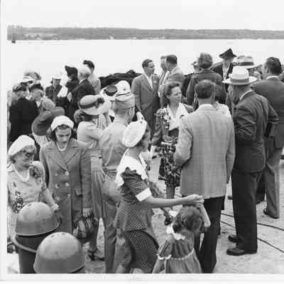 Unidentified group of people standing with Alva Smith in center