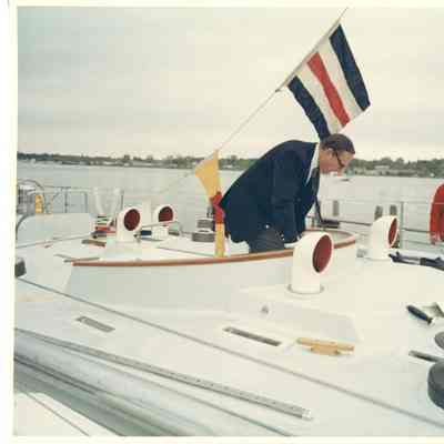 Man behind steering of Aura while docked