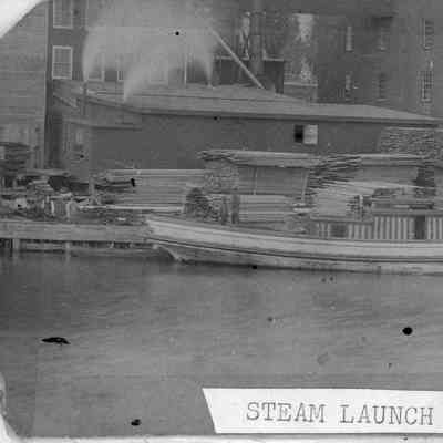 Lumber on docks with vessel Sheboygan around 1900