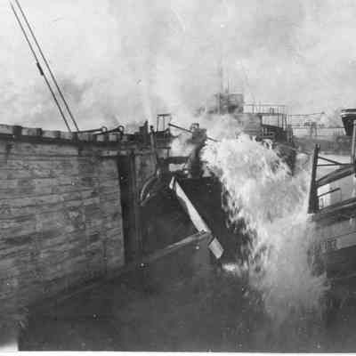 Water being pumped from the hull of a ship