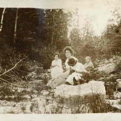 women and children on rocks