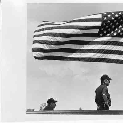 Three people on boat with American flag flying