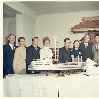 Group of people posing behind Alcoa Seaprobe model
