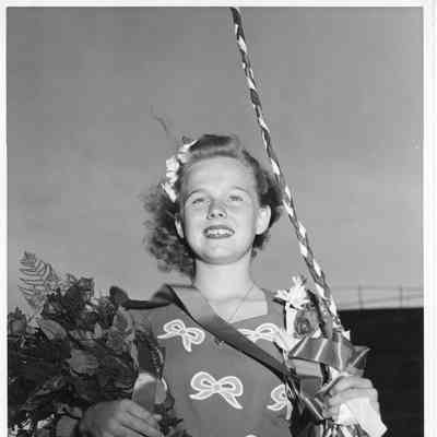 Patsy Smith holding roses at Alden Gifford christening