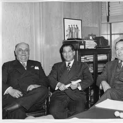 Three unidentified men sitting in office at Clement T. Jayne launching