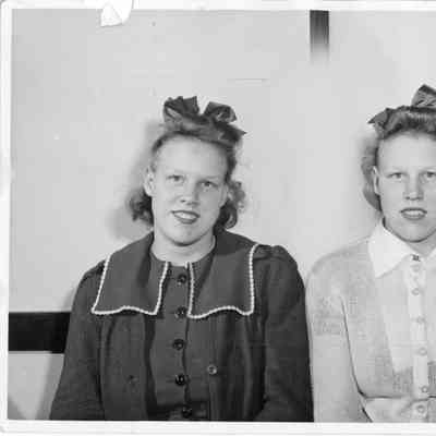 Two women wearing ribbons