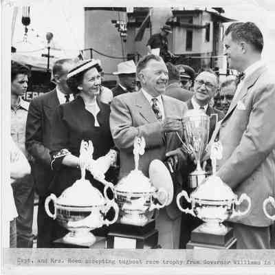 Captain and Mrs. Roen accepting tugboat race trophy Detroit 1953