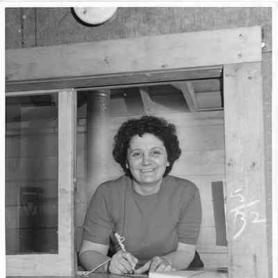 Woman at window with pen in hand