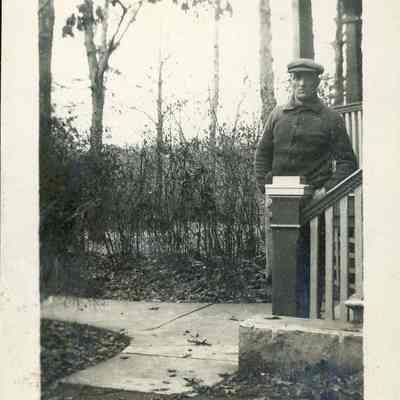 Man standing at foot of house