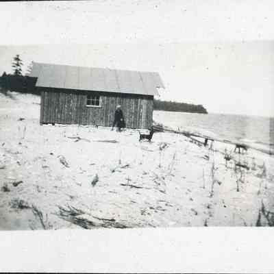 Donald Kincaide standing in front of a boathouse