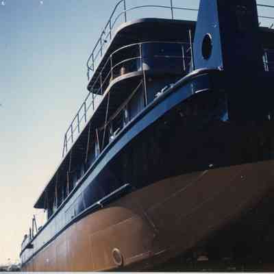 Blue and brown ship with two tiers of railing